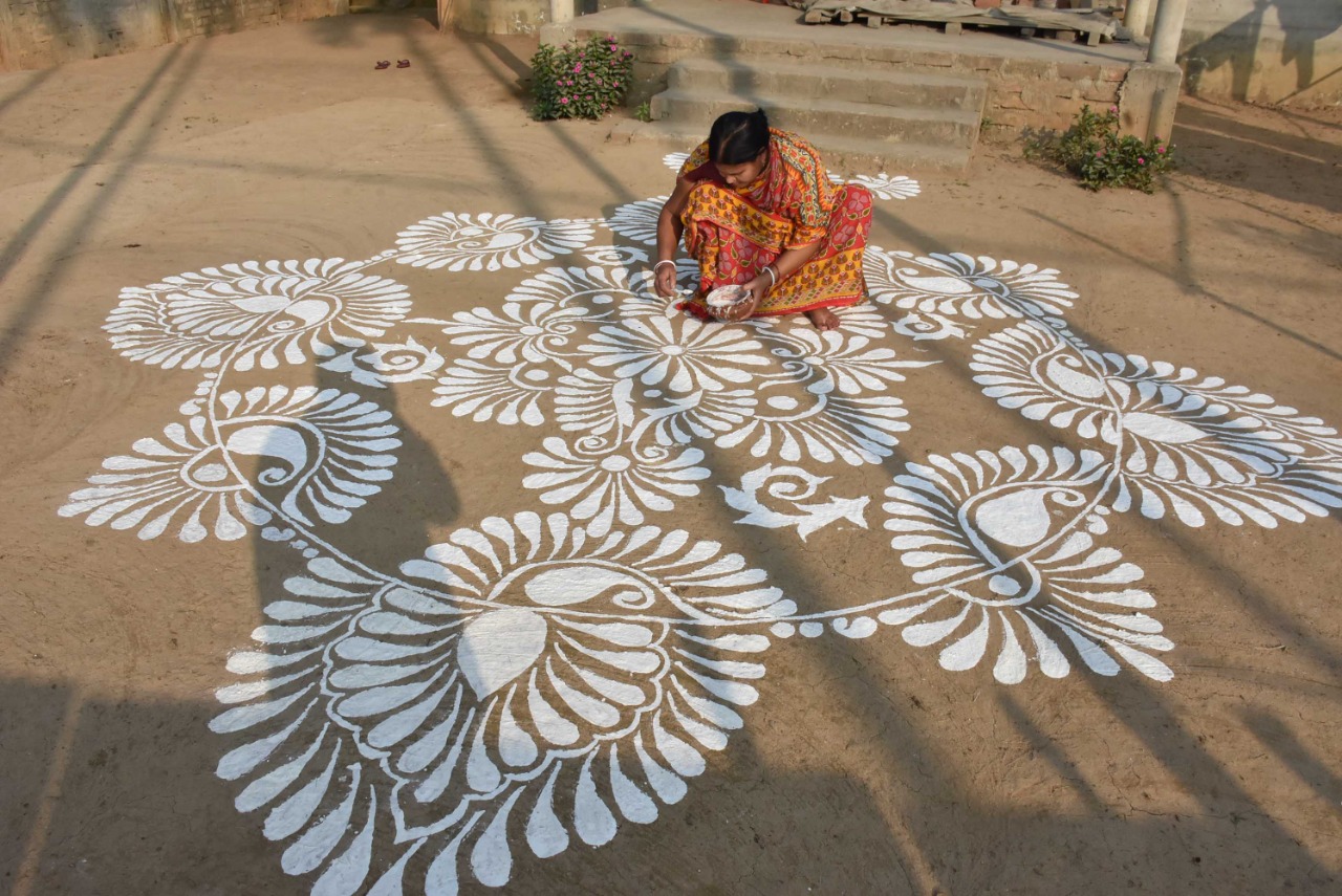 A Woman Painting 'Rangoli' Design On The Occasion Of 'Makar ...